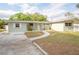 Inviting single-story home featuring a well-manicured lawn and a welcoming front entrance at 2332 S Crystal Lake Dr, Lakeland, FL 33801