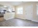 Living room features modern gray wood-look tile flooring and access to the updated white kitchen at 2332 S Crystal Lake Dr, Lakeland, FL 33801