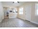 Living room showcases gray wood-look floors with views to the updated kitchen at 2332 S Crystal Lake Dr, Lakeland, FL 33801