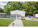 A backyard featuring a refreshing pool, shaded by trees, with a patio and seating area at 2332 S Crystal Lake Dr, Lakeland, FL 33801