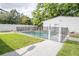 Sparkling in-ground pool surrounded by a secure fence and green lawn at 2332 S Crystal Lake Dr, Lakeland, FL 33801