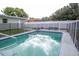 Backyard pool with crystal clear water and safety fences, nestled in a peaceful setting at 2332 S Crystal Lake Dr, Lakeland, FL 33801