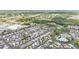 Aerial of the community showing the golf course, pool and surrounding businesses at 2511 Limewood Ave, Clermont, FL 34714