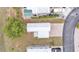 Drone shot featuring this home's white roof and brick driveway in a cozy community at 2511 Limewood Ave, Clermont, FL 34714