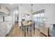 Cozy dining area features a wooden table, four chairs and a modern chandelier at 2511 Limewood Ave, Clermont, FL 34714