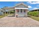 Charming home featuring a cozy awning, brick driveway, and well-maintained landscaping at 2511 Limewood Ave, Clermont, FL 34714