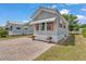 Charming home with a brick driveway and mature landscaping at 2511 Limewood Ave, Clermont, FL 34714