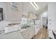 Well-lit kitchen with white appliances, cabinets and double stainless steel sink at 2511 Limewood Ave, Clermont, FL 34714