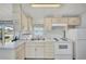 Bright kitchen featuring white appliances and ample counter space at 2511 Limewood Ave, Clermont, FL 34714