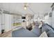 Cozy living room features lots of natural light and adjacent kitchen at 2511 Limewood Ave, Clermont, FL 34714