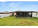 Well-maintained backyard featuring a screened-in porch and secure white fence at 2726 Red Egret Dr, Bartow, FL 33830