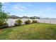 Well-maintained backyard with a white vinyl fence and lush landscaping, including palm trees at 2726 Red Egret Dr, Bartow, FL 33830