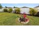 Lush backyard featuring a vinyl fence, vibrant plants, and a well-maintained lawn at 2726 Red Egret Dr, Bartow, FL 33830