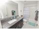 Bright bathroom featuring a granite countertop, modern vanity, and tiled shower with stylish shower curtain at 2726 Red Egret Dr, Bartow, FL 33830