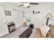 Cozy bedroom with ceiling fan, window, futon, ottoman, and side table, offering a comfortable living space at 2726 Red Egret Dr, Bartow, FL 33830