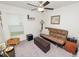 Cozy bedroom with ceiling fan, window, futon, ottoman, and side table, offering a comfortable living space at 2726 Red Egret Dr, Bartow, FL 33830