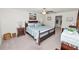 Comfortable bedroom featuring a wooden bed frame, ceiling fan, and neutral-toned decor, creating a relaxing space at 2726 Red Egret Dr, Bartow, FL 33830