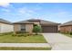 Charming single-story home with a well-manicured lawn, complemented by a two car garage and beautiful landscaping at 2726 Red Egret Dr, Bartow, FL 33830
