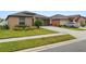 Beautiful single-story home with a manicured lawn and landscaping, adjacent to a driveway with a parked car at 2726 Red Egret Dr, Bartow, FL 33830