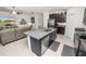 Open kitchen with a large island, dark cabinets, granite countertops, and stainless steel appliances at 2726 Red Egret Dr, Bartow, FL 33830