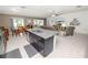 Open kitchen with an island, dark cabinets, granite counters, and seamless flow into the dining and living areas at 2726 Red Egret Dr, Bartow, FL 33830