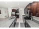Spacious kitchen featuring dark cabinets, granite countertops, stainless steel appliances, and a large island at 2726 Red Egret Dr, Bartow, FL 33830
