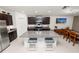 Modern kitchen featuring dark wood cabinetry, granite countertops, and a large island with seating at 2726 Red Egret Dr, Bartow, FL 33830
