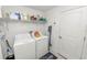 Functional laundry room featuring a washer, dryer, storage shelves, and organized cleaning supplies at 2726 Red Egret Dr, Bartow, FL 33830