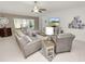 Spacious living room with tile flooring, ceiling fan, and a large window providing ample natural light at 2726 Red Egret Dr, Bartow, FL 33830