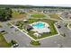 Aerial view of community pool and clubhouse with lounge chairs and umbrellas at 2726 Red Egret Dr, Bartow, FL 33830