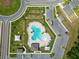 Aerial view of the community pool with sun loungers and umbrellas in a residential area at 2726 Red Egret Dr, Bartow, FL 33830