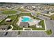 Aerial view of community pool, playground, clubhouse and parking with surrounding homes at 2726 Red Egret Dr, Bartow, FL 33830