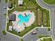 Aerial view of the community clover-shaped pool and clubhouse with lounge chairs and umbrellas at 2726 Red Egret Dr, Bartow, FL 33830