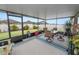 Spacious screened-in patio features a table with swivel chairs and views of the fenced backyard at 2726 Red Egret Dr, Bartow, FL 33830