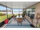 Relaxing screened-in patio with outdoor seating, ceiling, and views of the well-maintained backyard at 2726 Red Egret Dr, Bartow, FL 33830