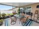 Enjoy the screened-in patio with outdoor seating, lush plants, and serene backyard views at 2726 Red Egret Dr, Bartow, FL 33830