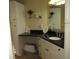 A well-lit bathroom features a vanity with storage and a sleek granite countertop at 281 Glenridge S Loop, Lakeland, FL 33809