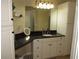 A stylish bathroom features a granite countertop and ample storage in the cabinets at 281 Glenridge S Loop, Lakeland, FL 33809