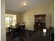 A cozy dining room features dark wood flooring and furniture, bathed in natural light at 281 Glenridge S Loop, Lakeland, FL 33809