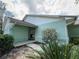 Charming entrance with light green exterior, well-maintained landscaping, and a welcoming walkway at 281 Glenridge S Loop, Lakeland, FL 33809