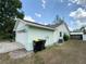 The side exterior features a two-car garage and light green paint at 281 Glenridge S Loop, Lakeland, FL 33809