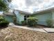 Well-maintained exterior with fresh paint, manicured bushes, and a clean walkway at 281 Glenridge S Loop, Lakeland, FL 33809