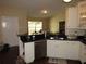 Bright kitchen with white cabinets and a breakfast bar overlooking the dining area and backyard at 281 Glenridge S Loop, Lakeland, FL 33809