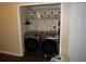 Washer and dryer closet with storage and shelving for laundry supplies at 281 Glenridge S Loop, Lakeland, FL 33809
