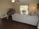 Comfortable living room with wood floors, a gray sofa, and sliding glass doors to the patio at 281 Glenridge S Loop, Lakeland, FL 33809