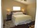 A cozy main bedroom bathed in warm light, featuring a comfortable bed at 281 Glenridge S Loop, Lakeland, FL 33809