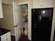 Pantry next to black refrigerator stocked with various pantry staples at 281 Glenridge S Loop, Lakeland, FL 33809