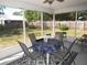 Covered porch with outdoor furniture and view of the fenced yard at 281 Glenridge S Loop, Lakeland, FL 33809