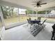 Cozy screened-in porch with a table, four chairs, and a ceiling fan perfect for outdoor dining at 281 Glenridge S Loop, Lakeland, FL 33809