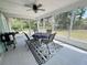 Inviting screen porch with a table, chairs, ceiling fan, and backyard views for relaxation and entertaining at 281 Glenridge S Loop, Lakeland, FL 33809